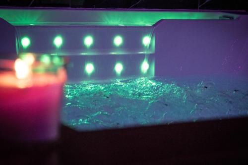 a pool of water with green lights on it at Suite Élite in Catania