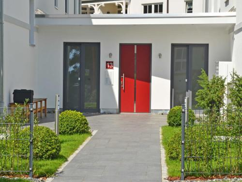 a red door on the side of a building at Residenz Margarete - Penthouse 2.7 in Binz