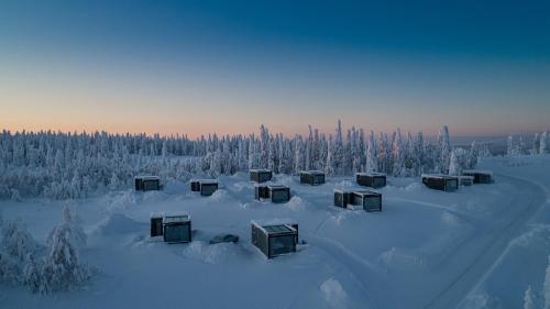 a group of boxes sitting in the snow at Ukkohalla Sky Cabin Glass Suite in Hyrynsalmi