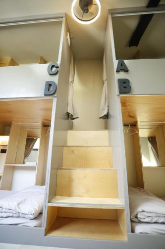 a staircase in a room with two beds at Walking Island in Xiaoliuqiu