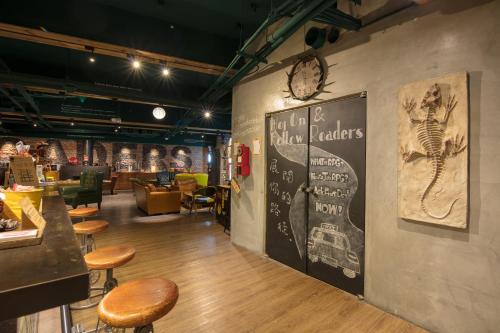 a restaurant with stools and a menu on the wall at Roaders Hotel Zhonghua in Taipei