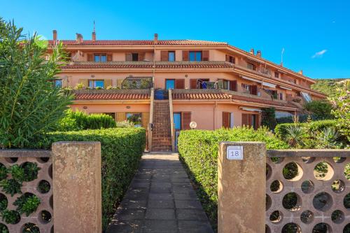 a large orange building with a staircase in front of it at Casa Erica in Palau
