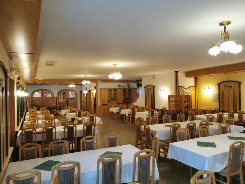 a dining room with white tables and chairs at Landrasthaus Maria Bild in Maria Bild