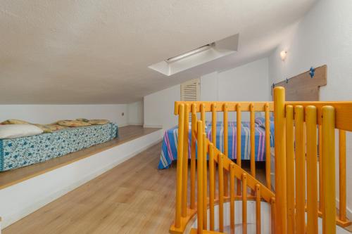 a bedroom with two beds and a crib at A due passi dal mare in Palau