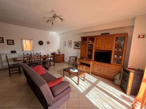 a living room with a couch and a dining room at Casa Gianfranco in Gubbio