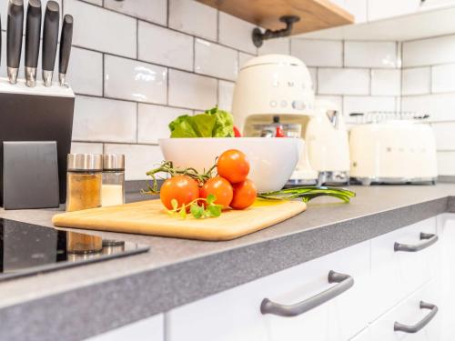 a cutting board with tomatoes on top of a kitchen counter at OSTSEELOFT BINZ - Villa Amanda WG 08 in Binz
