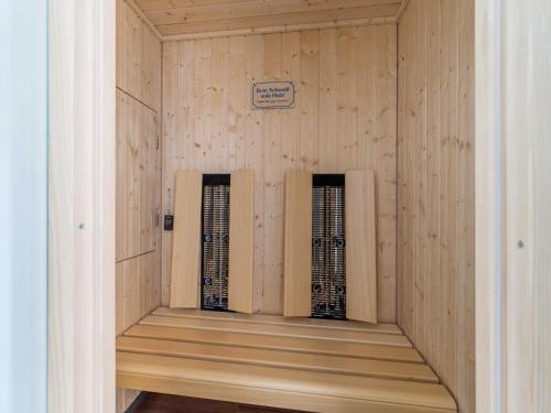 a sauna with two windows in a wooden wall at OSTSEELOFT BINZ - Villa Amanda WG 08 in Binz