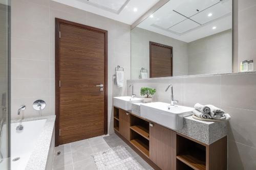 a bathroom with two sinks and a large mirror at Close To Metro with Frame View in Dubai