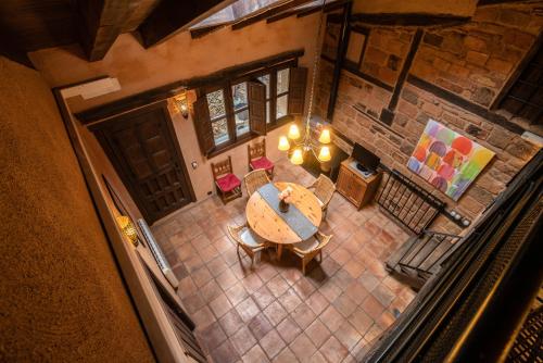 an overhead view of a dining room with a table and chairs at Sierra de Gata EL CORRAL DE LA HIGUERA in Torre de Don Miguel