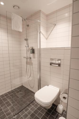 a bathroom with a shower and a toilet in it at Comfort Hotel Malmö in Malmö