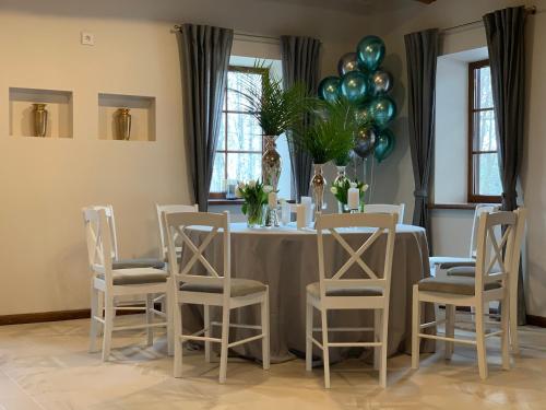 a table with a bunch of balloons and chairs at Auksinio elnio slėnis in Rukliai