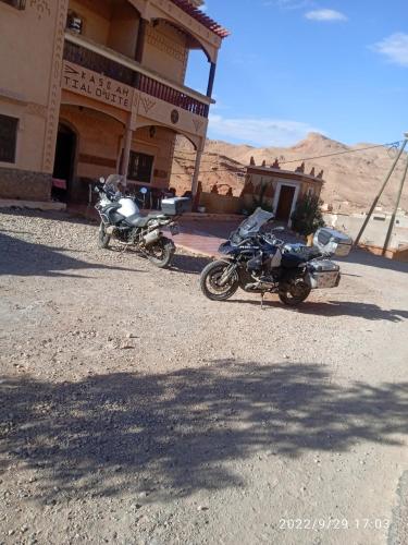 two motorcycles parked in front of a building at Kasbah Tialouite in Kalaat MGouna