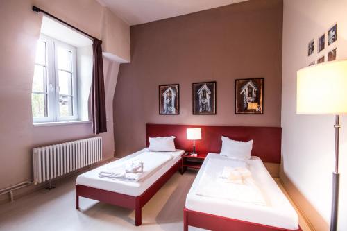 Łóżko lub łóżka w pokoju w obiekcie PLUS Berlin Hostel und Hotel