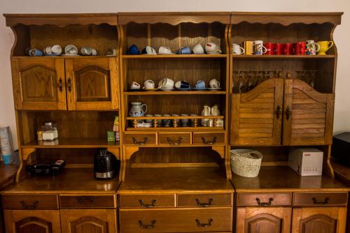 a kitchen with wooden cabinets and a counter top at Casa Flavius in Văliug