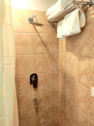 a bathroom with a shower with a shower head at The Sarai, Hotel in Jaipur