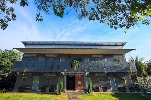 a building with a solarium on top of it at Phuket Nonnita Boutique Resort & Organic Farm in Phuket