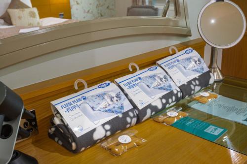 two boxes on a glass table in a hotel room at The Pheasant Hotel, Holt, Norfolk - The Coaching Inn Group in Kelling