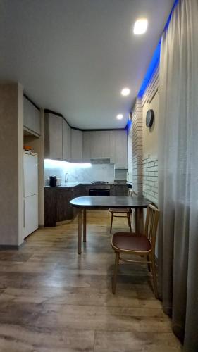 a kitchen with a table and chairs in a room at "Чернігівська тиша" in Chernihiv