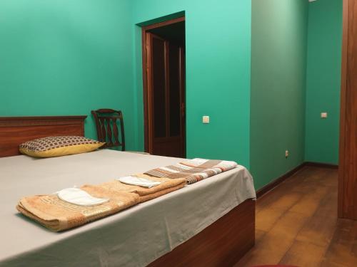 a bedroom with a bed with blue and green walls at Orran Hotel and Resort in Solak