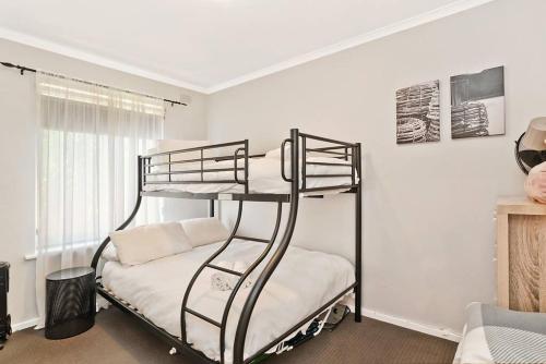 a bedroom with two bunk beds in a room at West Beach Family Beauty - 2 Bed Unit in Henley Beach