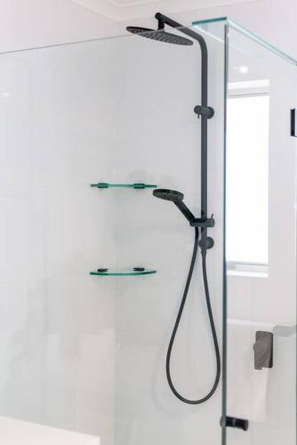 a shower in a bathroom with a glass door at West Beach Family Beauty - 2 Bed Unit in Henley Beach