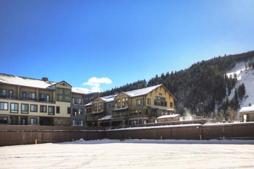 a group of buildings with snow on the ground at Slopeside in Keystone