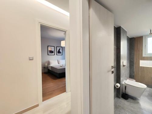 ein Bad mit WC und ein Bett in einem Zimmer in der Unterkunft Etolou C2 - by Verde Apartments in Athen