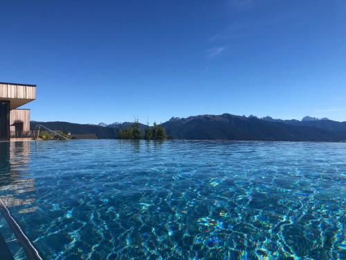 a view of a large body of water at Tratterhof Mountain Sky Hotel in Maranza