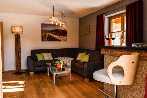 a living room with a couch and a table at Landhaus Geierstanger in Wallgau