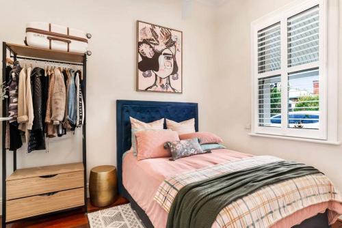 a bedroom with a bed and a dresser and a window at Cute as a Button - Picket Fence 3 Bed Stylish Home in Unley
