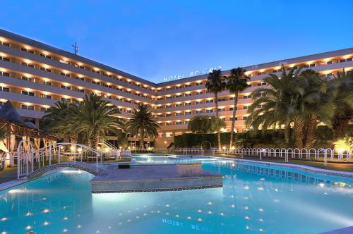 a hotel with a pool in front of a building at Beatriz Toledo Auditorium & Spa in Toledo