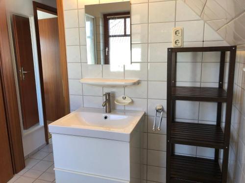 un bagno con lavandino e specchio di Ferienwohnung-Mary-Poppins-mit-Balkon-zwischen-Strand-Wald-Wiese-im-Suedosten-der-Insel-Ruegen a Gustow
