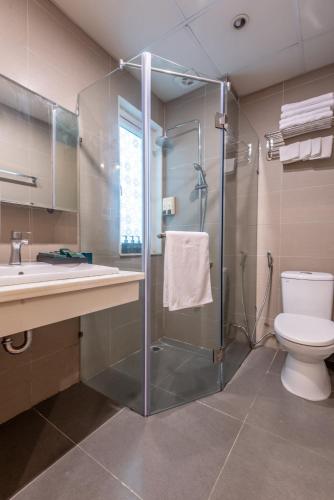 a bathroom with a shower and a toilet and a sink at Hanoi Golden Sunshine Villa Hotel and Travel in Hanoi