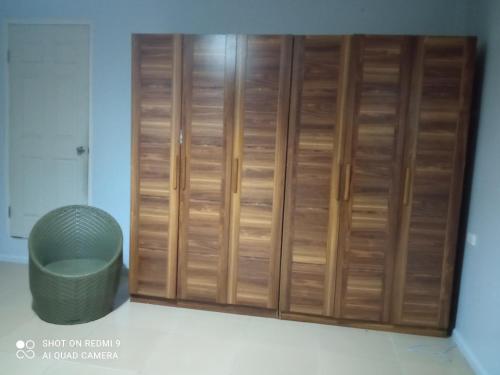 a wooden closet with a trash can in a room at Marine Apartments in Honiara