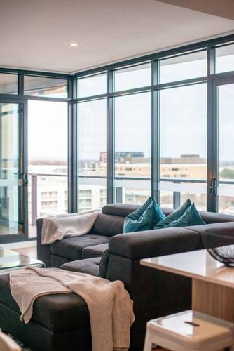a living room with two couches and a large window at Stunning Views 2BR Luxury Pool Parking Gym WiFi in Adelaide