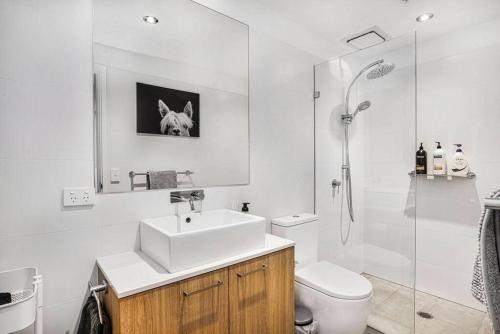 a bathroom with a sink and a shower and a toilet at Stunning Views 2BR Luxury Pool Parking Gym WiFi in Adelaide
