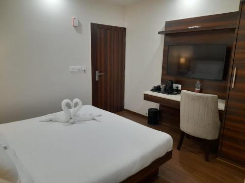 Cama o camas de una habitación en Sai Maa Hotel & Residency