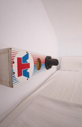 a bed frame with anorwegian flag on the side at Boutique Hostal La Curandera de Salinas in Ibiza Town