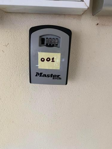 an electronic clock on the wall of a room at Dellmar Apartment in Perea