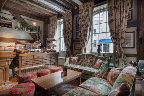 The White Horse Hotel, Romsey, Hampshire في رومسي: غرفة معيشة مع أريكة وطاولة