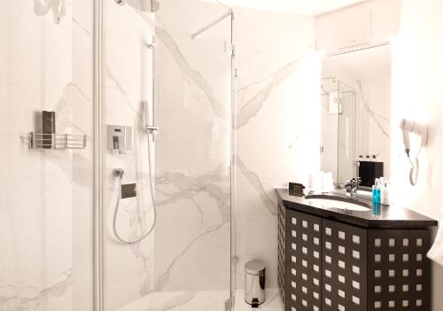 a bathroom with a shower and a sink at Hotel Sonne Sissach in Sissach