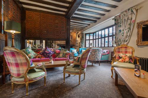 a living room with couches and chairs and a table at The White Horse Hotel, Romsey, Hampshire in Romsey