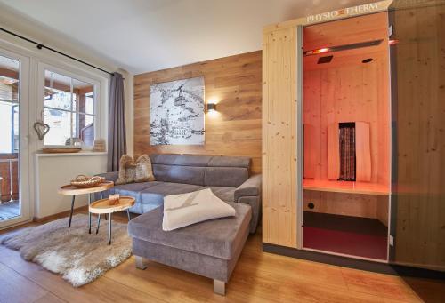 a living room with a couch and a table at Appartement Iglsberg Top 7 in Saalbach Hinterglemm