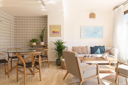 a living room with a table and a couch at Puerta Catedral Apartments in Seville