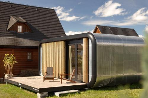 a tiny house on a deck in front of a house at Liptovské Chaty - Fashion Line in Liptovský Mikuláš