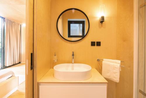 a bathroom with a sink and a mirror at Liptovské Chaty - Fashion Line in Liptovský Mikuláš