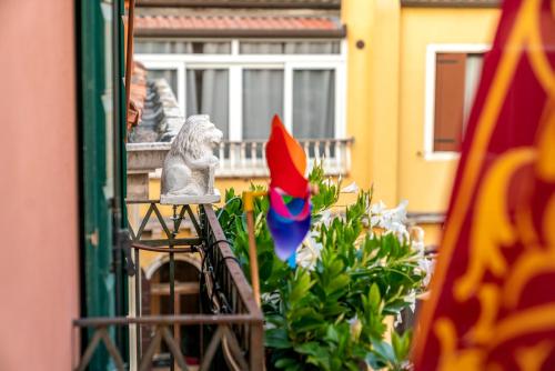 a view of a balcony with a statue and flowers at Palazzo San Luca in Venice