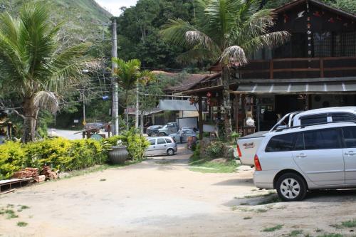 a street with cars parked in front of a building at Pousada Portal de Lumiar in Lumiar