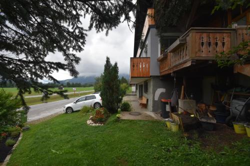 a white car parked in front of a house at Almblick Energiequelle in Bad Mitterndorf