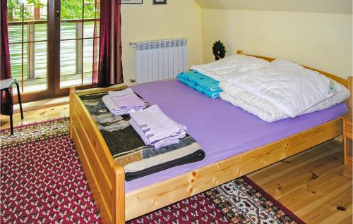a bed with white sheets and towels on it at Beautiful Home In Grunwald With Wifi in Mielno